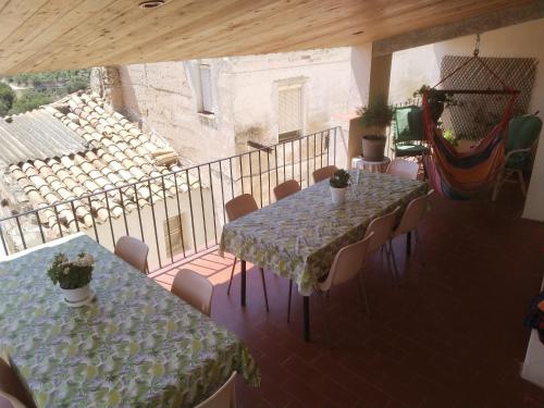 a room with two tables and chairs and a balcony at CAL BENAIGES in Tartareu