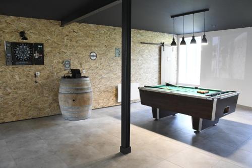 a room with a pool table and a barrel at Gîte moulin de Chaussac proche du Puy duFou in Saint-Laurent-sur-Sèvre