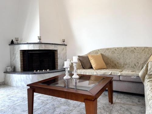 a living room with a couch and a coffee table at La Casa di Leone Casa Sorella in Svoúrou Metókhion