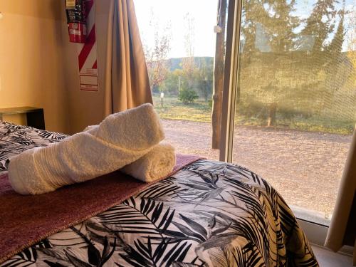 a bedroom with a bed and a window at Cabañas EcoNature in Valle Grande