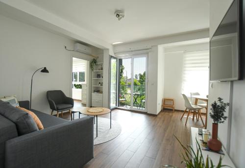 a living room with a couch and a table at Apartman Plaža 2 in Kladovo