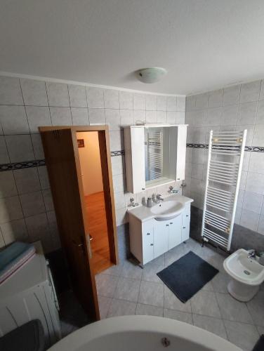 a bathroom with a sink and a toilet at Barišić in Livno