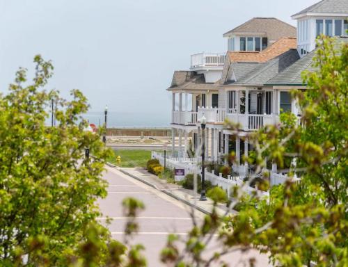 a row of houses on a street with trees at AMAZING!!!! Luxury 5BR, Steps to beach and Fun! Fully Renovated Beach house! in Atlantic City