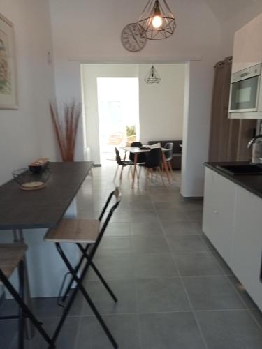 a kitchen and dining room with a table and chairs at chez jean.mi in Millas