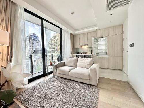 a living room with a couch and a large window at Sukhumvit 11#Luxury#Pool#Gym#BTS Nana&MRT Sukhumvit#1BR#Max2ppl in Bangkok