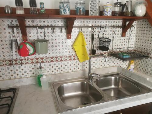 a stainless steel sink in a small kitchen at Casa Vacanza Alma in Cefalù
