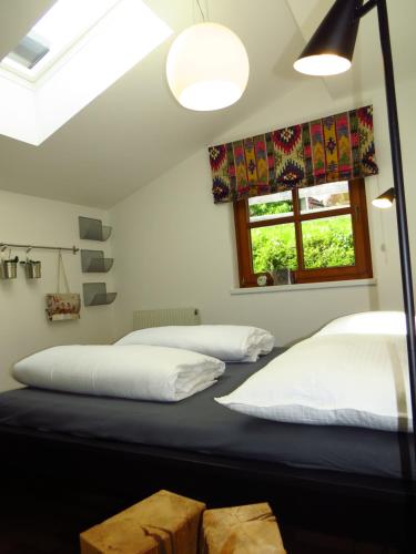 a bedroom with two beds and a window at Art Appartement in Niedernsill