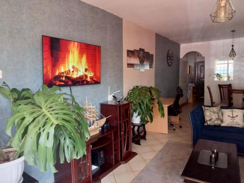 a living room with a fire place in the wall at Cosy, serene and affordable 2bdr apartment off Waiyaki way in Nairobi