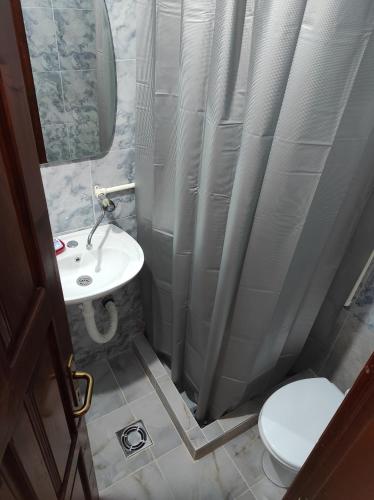 a bathroom with a sink and a toilet and a mirror at Orange House in nature in Žabljak