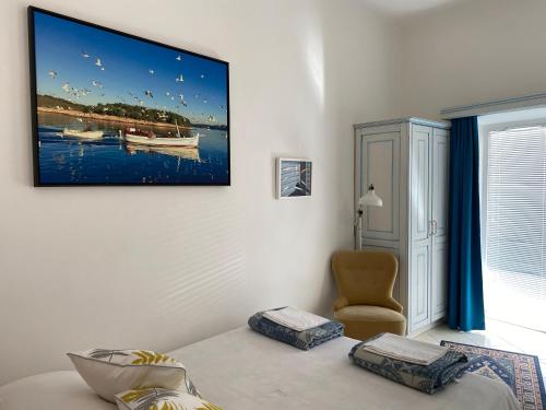 a room with a bed and a picture on the wall at Apartments Skiljan in Crikvenica