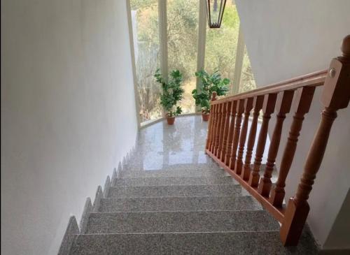 a staircase in a house with a stair case at Qerana's rooms: Corner of nature in Golem