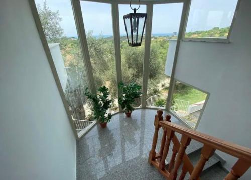 a view of a room with large windows at Qerana's rooms: Corner of nature in Golem
