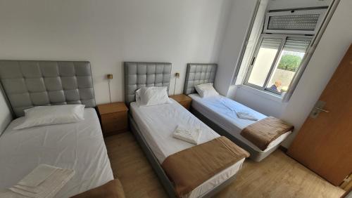 Cette petite chambre comprend 2 lits et une fenêtre. dans l'établissement Stay in Sintra, à Sintra