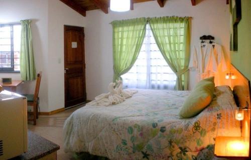 a bedroom with a bed in a room with windows at Complejo Sol in Villa Carlos Paz
