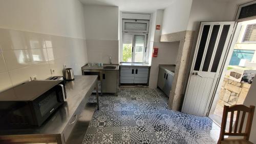 a kitchen with a sink and a tv in it at Stay in Sintra in Sintra