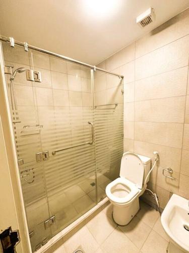a bathroom with a shower and a toilet and a sink at central apartment for rent 28 in Umm Uthainah