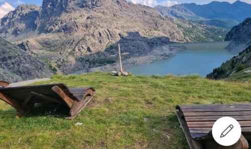 a bench on a hill with a view of a mountain at Mary House in Sondrio
