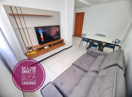 a living room with a couch and a tv at TH Flats GV in Governador Valadares