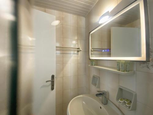 a bathroom with a sink and a mirror at Villa Clelia in Vasilikos
