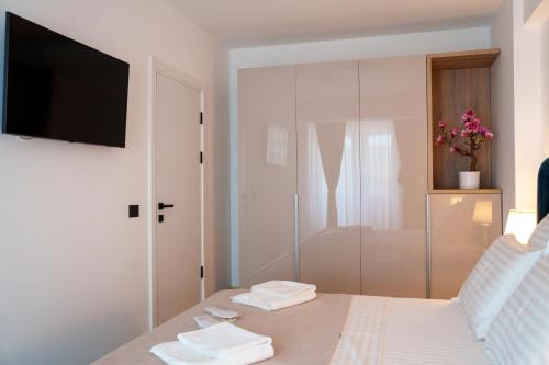 a bedroom with a bed with a tv on a wall at Valleta Sea View Infinity Beach Pool&Spa in Mamaia Nord