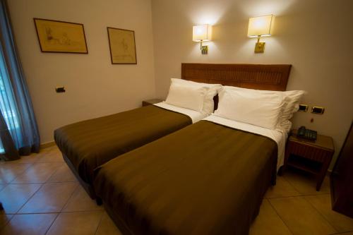 Letto o letti in una camera di Hotel Forum