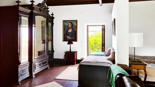 a bedroom with a bed and a large mirror at Quinta do Sanguinhal in Rio Maior
