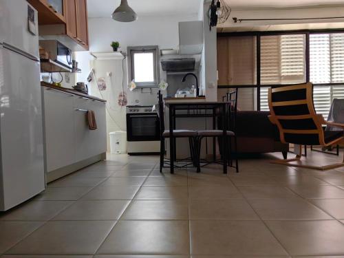 a kitchen with a table and some chairs and a counter at near the sea even 14 days won't feel enough in Bat Yam