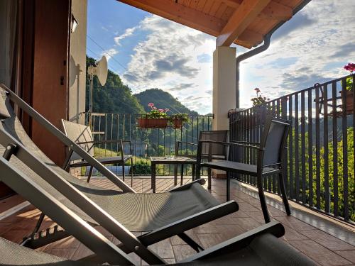 a couple of chairs sitting on a porch with a view at Casa Modigliani - Tra Arte e Natura in San Quirico