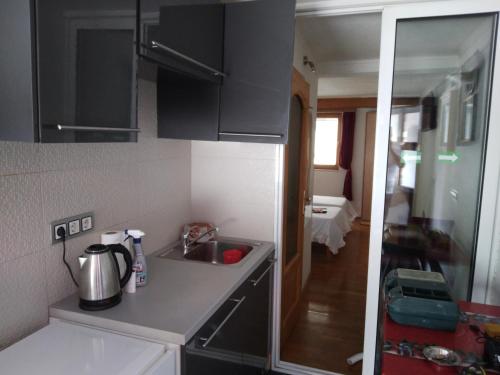 a kitchen with a sink and a counter top at Apartman MV in Sarajevo