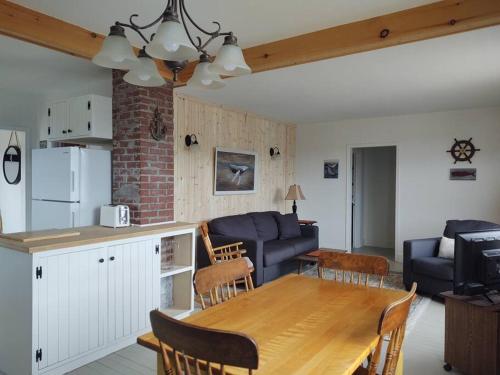 a kitchen and living room with a table and a couch at North Sea Whale House in Princeton