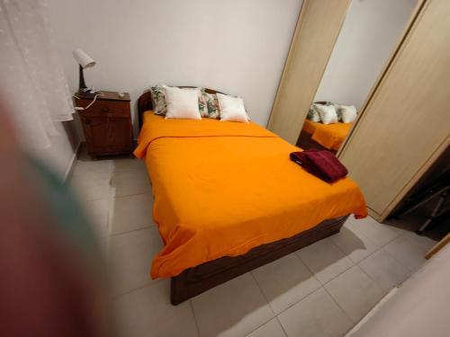 a small bedroom with a bed and a mirror at near the sea even 14 days won't feel enough in Bat Yam