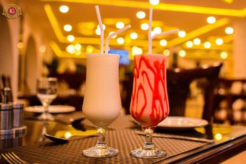two cocktails sitting on a table in a restaurant at Jovial Gold Naran in Nārān