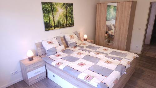 a bedroom with a large bed with pillows at Ferienwohnung Rodder Maar in Niederzissen