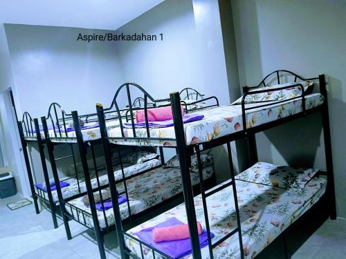 a group of bunk beds in a room at 2020 Travelers Inn in Dumaguete