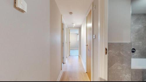 a hallway with a hallway leading to a bathroom at Stylish Ensuite in Maryhill in Maryhill