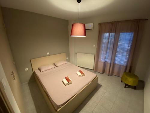 a bedroom with a bed with two pillows on it at Voulas suites in Eleftheroúpolis