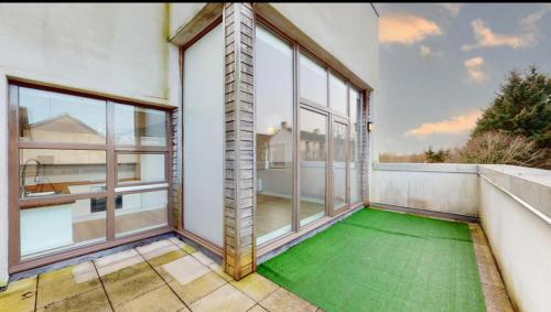 un balcón vacío con un suelo verde en una casa en Stylish Ensuite in Maryhill en Maryhill