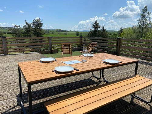 a wooden table sitting on top of a deck at L’escapade de Tali in Talizat