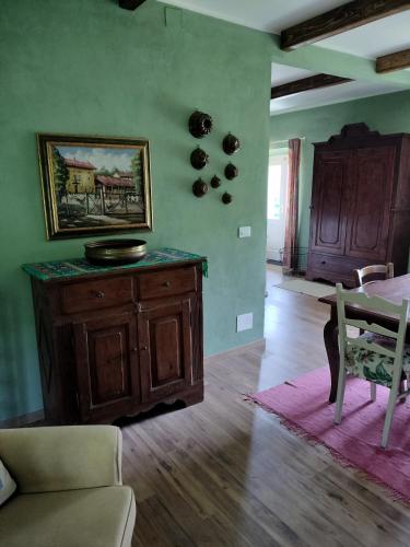 a living room with a couch and a table at Casa relax immersa nel verde della natura in Casalborgone
