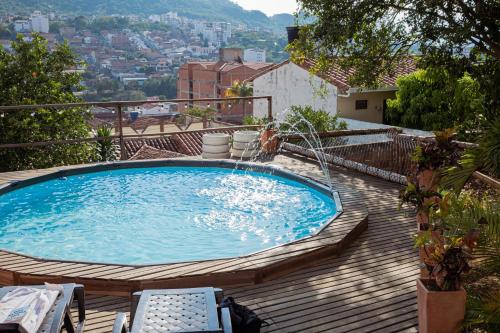 a swimming pool on a deck with a view of a city at Traveler Hostel in San Gil