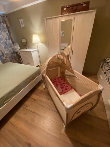 a bedroom with a bed and a crib with a mirror at Casa di Lucy Umbria in Foligno