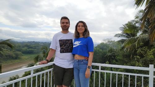 a man and a woman standing next to a fence at Mahaweli View Inn in Kandy