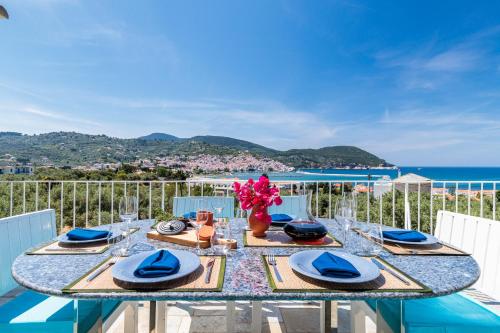 mesa de comedor con vistas al océano en Sunshine Pool Villa near the Sea, en Skopelos Town
