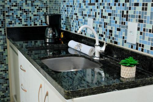 a kitchen counter with a sink and a coffee maker at Tropical Executive 1305 with VIEW in Manaus