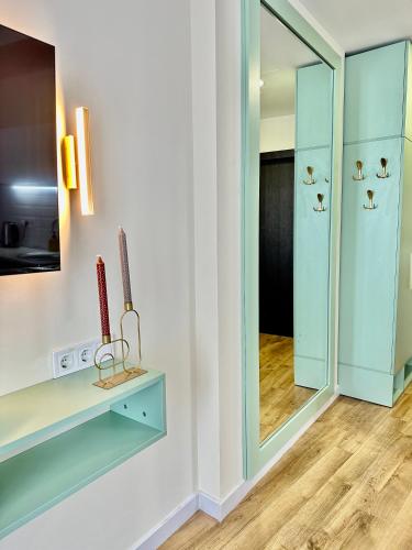 a dressing room with a mirror and a television at Nina apartment in Batumi