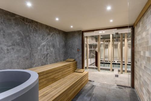 a bathroom with a soaking tub and a window at Hotel Vinifera Wine & Spa 5 Stars Superior in Balatonfüred