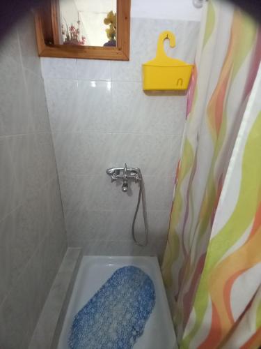 a bathroom with a bath tub with a shower at AGATHA appartments PALIOURIA in Kókkinon Nerón
