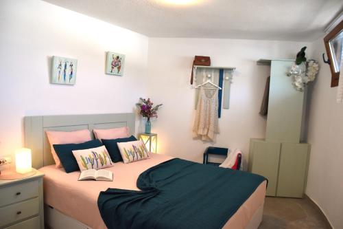 a bedroom with a bed with a book on it at La Belle Vie in Famara