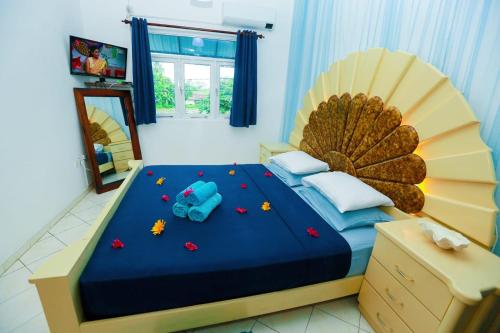 a bedroom with a large bed with a blue comforter at Luxury My Villa Bentota 200m Bentota Beach in Bentota