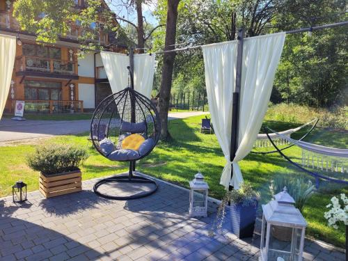a swing in a yard next to a garden at Aparthotel Góralski Spa 2 in Białka Tatrzanska
